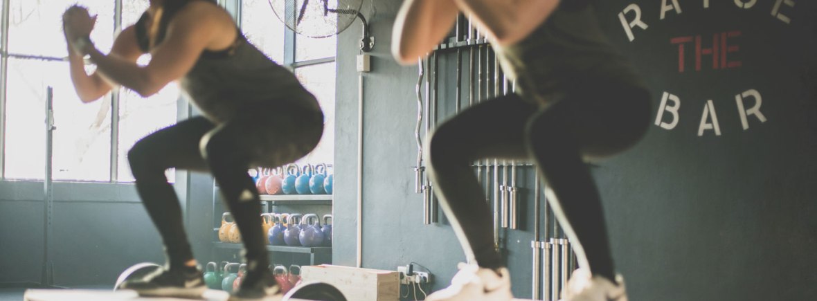 Ladies squatting on plyo box Photo by Meghan Holmes on Unsplash